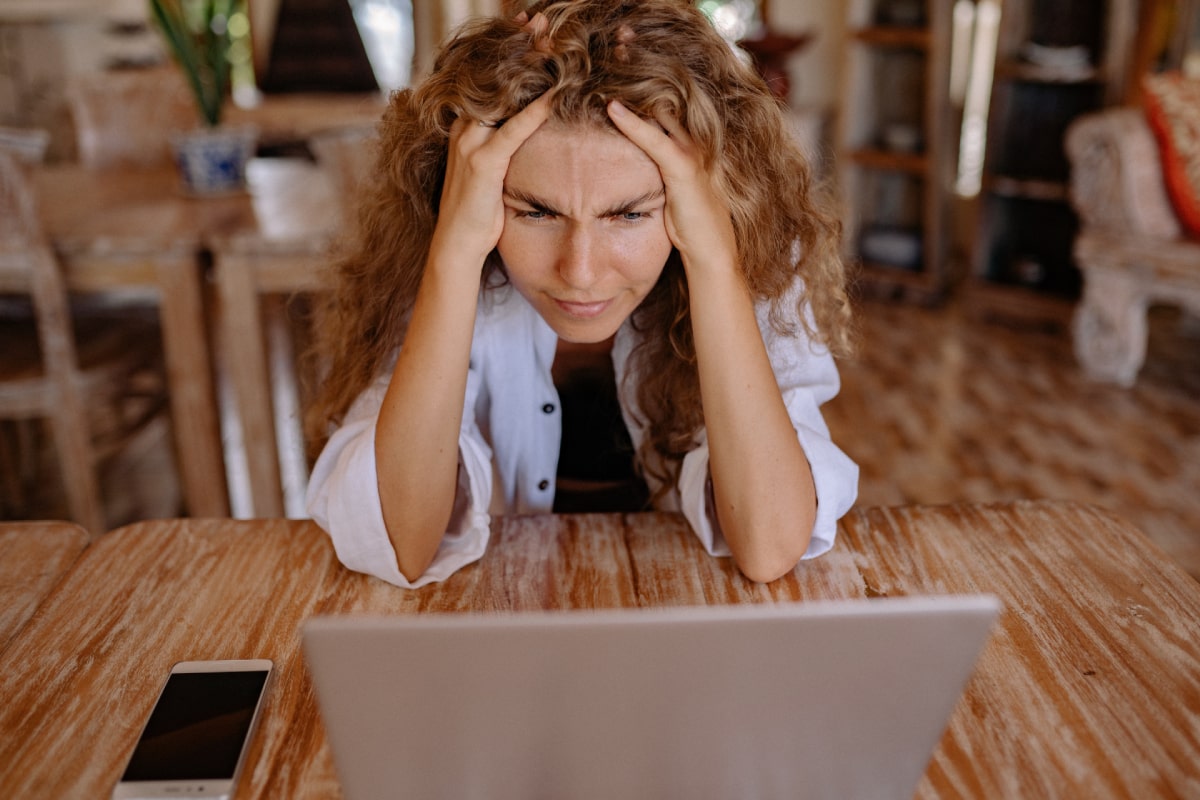 Stressed out woman looking at her computer